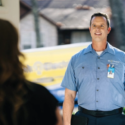 Mr Electric technician talking to customer.