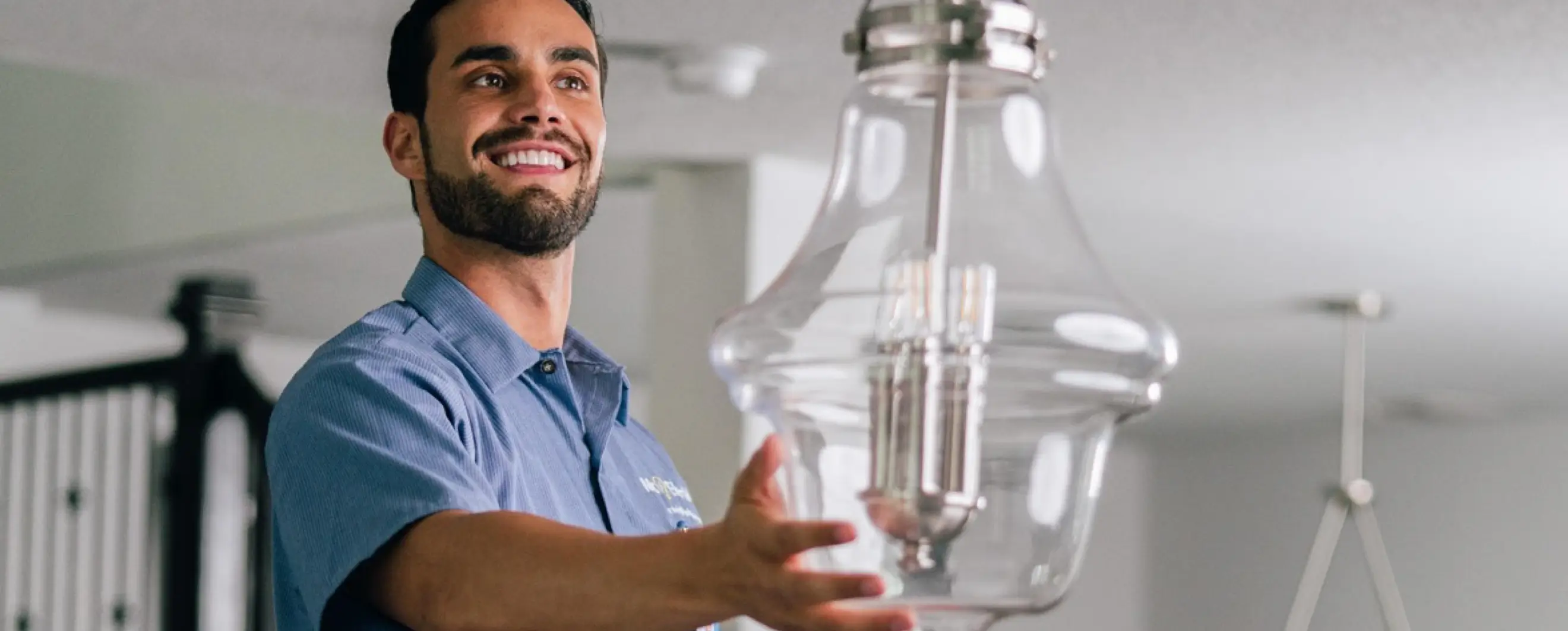 Mr. Electric technician installing a chandelier.