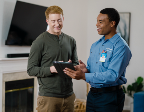 Mr. Electric technician talking to customer about smart home televisions.