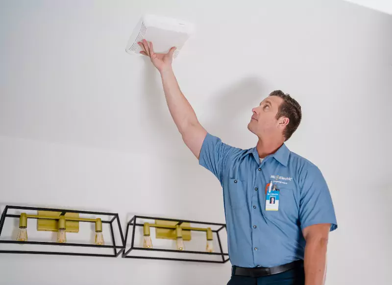 A Mr. Electric of Palo Alto electrician installing a carbon monoxide detector.