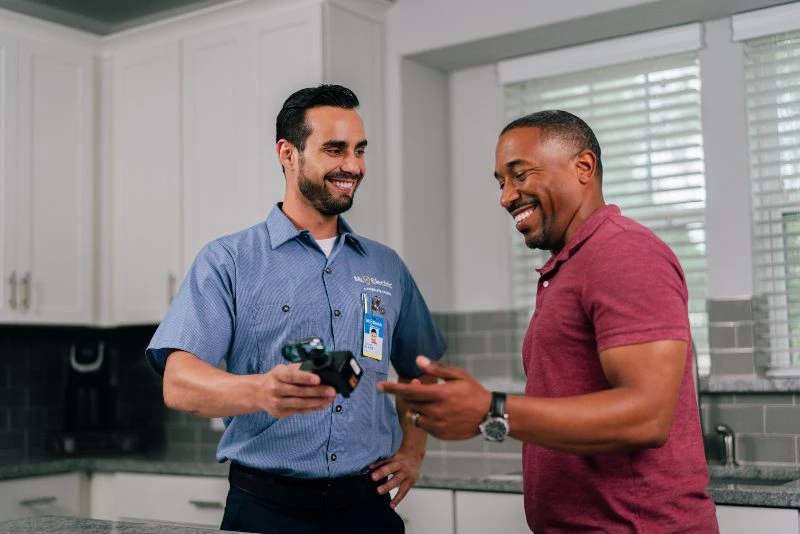 MRE electrician showing an electrical panel to customer.