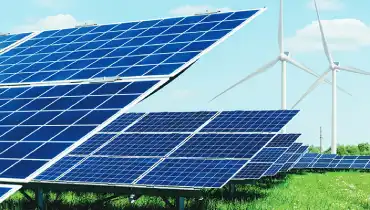 Solar panels and wind turbines in a field.